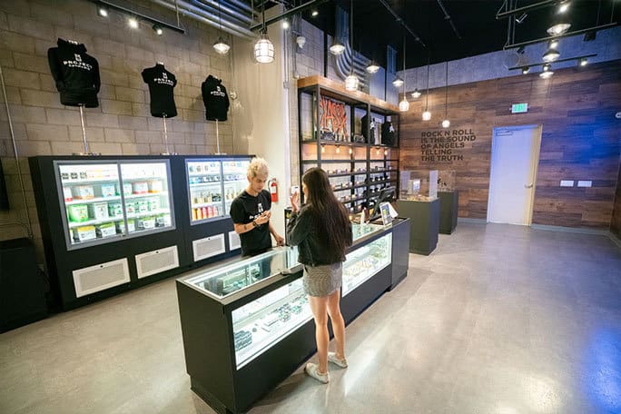 Project Cannabis Store indoor, seller talking to a woman